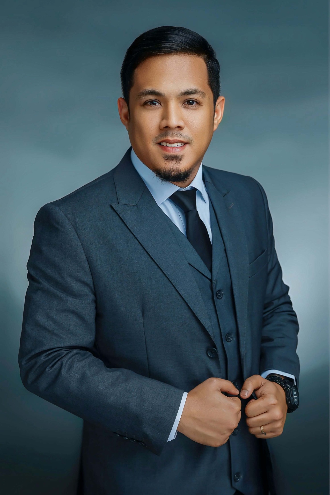 Jose Cabuhat Publico Jr. wearing a navy suit, with the full original portrait framing visible